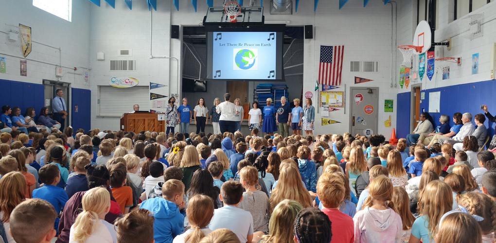 Rogers students sitting down learning about international peace day